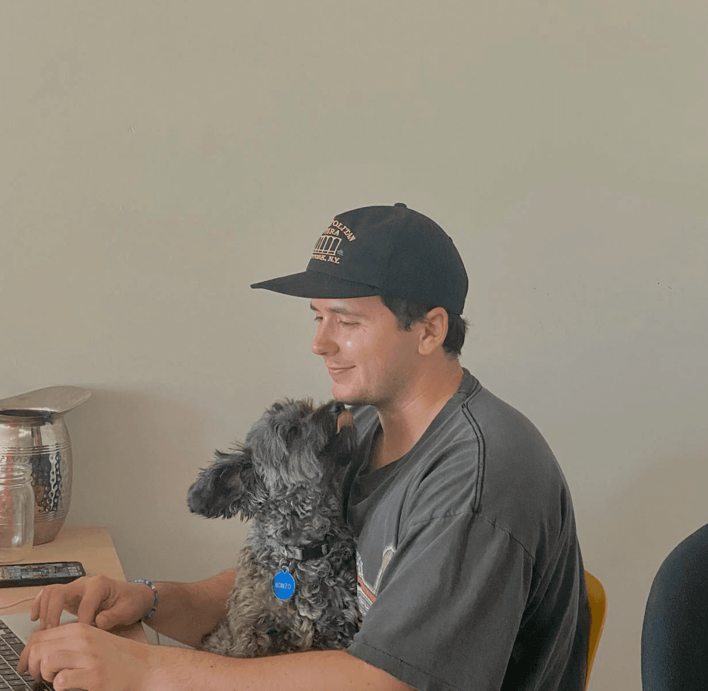Lior at a laptop with Bonzo the dog on his lap