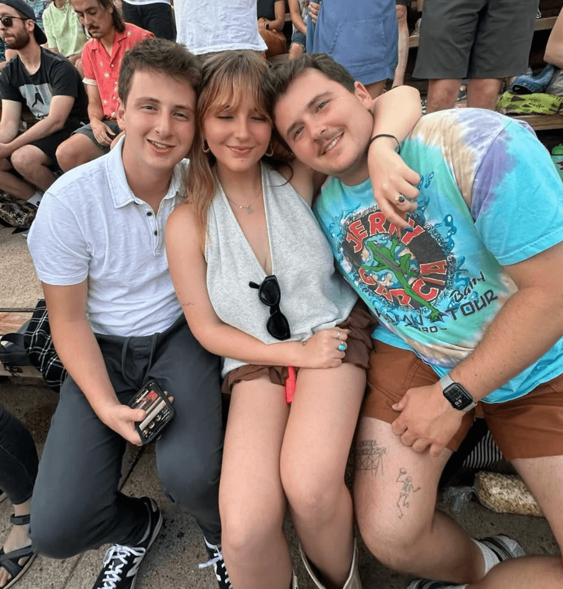 Lior with friends on the bleachers at an outdoor concert