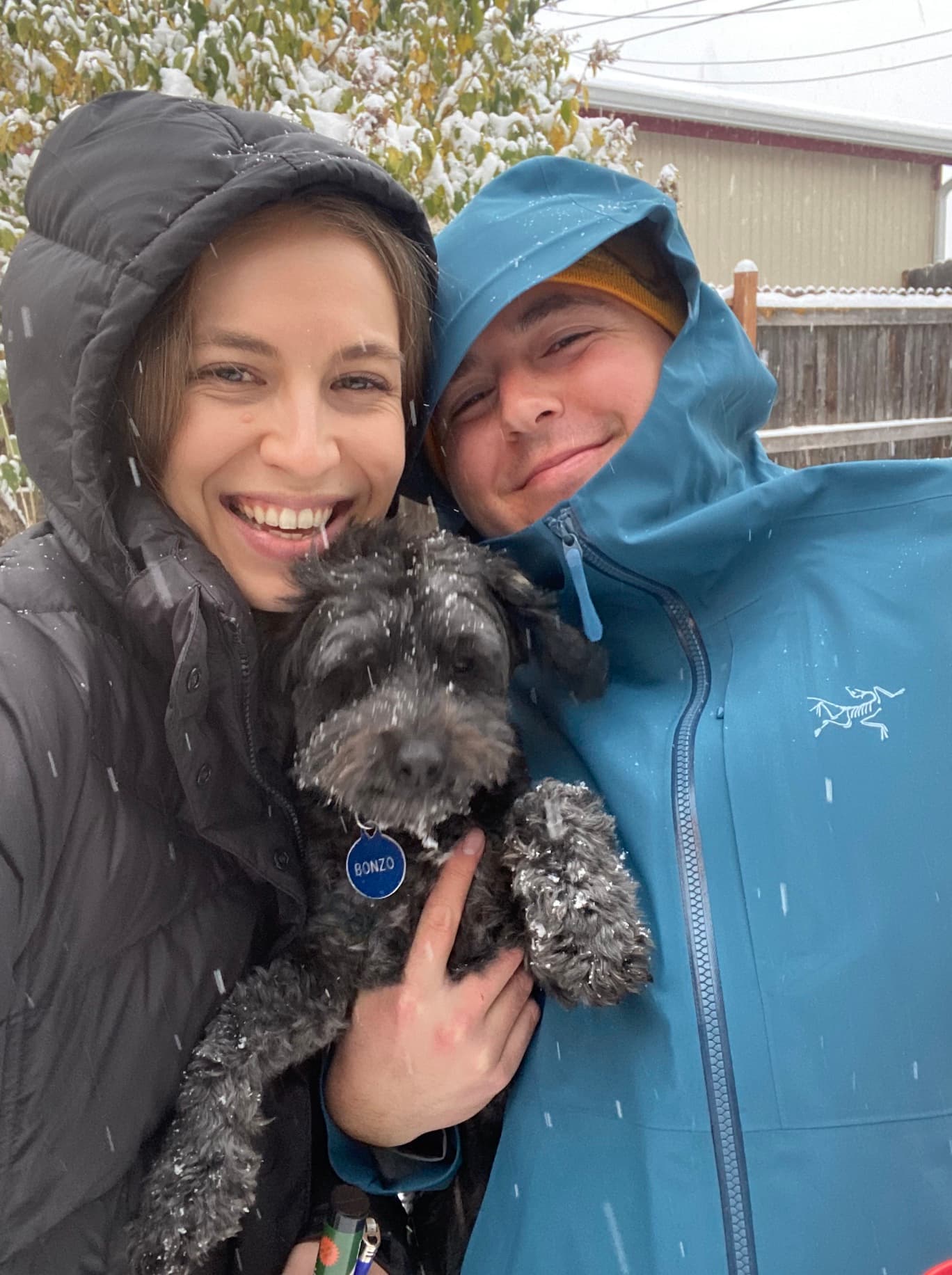 Lior and Sam holding Bonzo in the snow